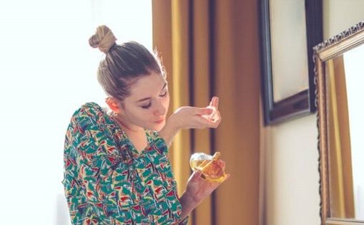 woman testing perfume to see if its expired