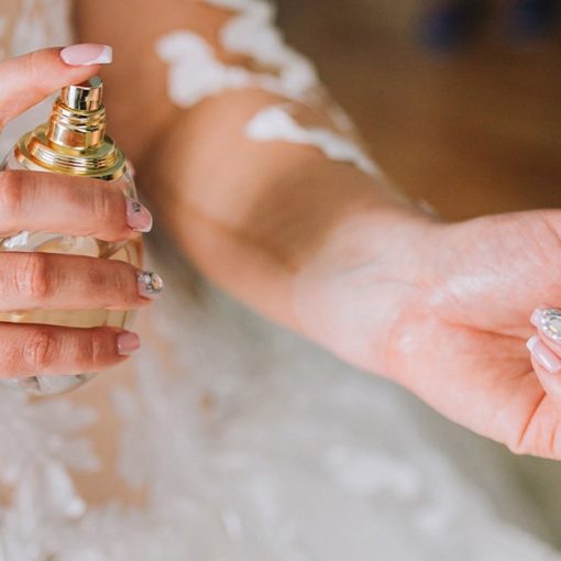 a june bride applies fragrance before her wedding