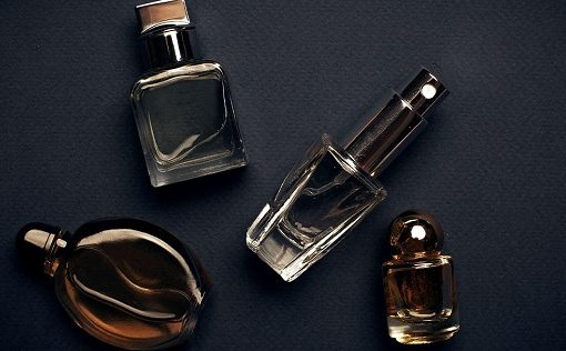 man spraying cologne