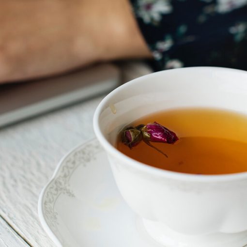 a cup of tea with a flower in it