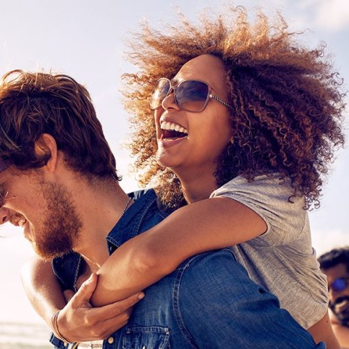 man and woman enjoy summer while wearing blue fragrances