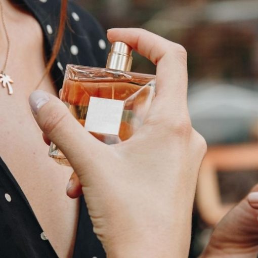women tests out different valentino perfumes for women at department store