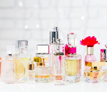 a collection of different perfumes sitting on a white counter