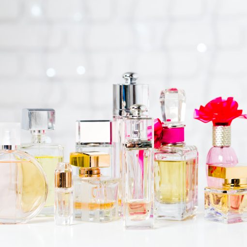 a collection of different perfumes sitting on a white counter