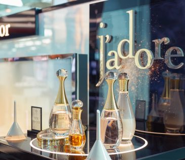 product display at a Dior store featuring four Christian Dior perfumes