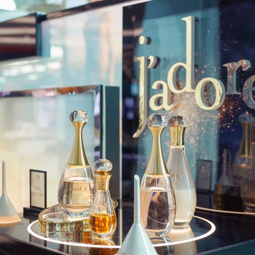 product display at a Dior store featuring four Christian Dior perfumes