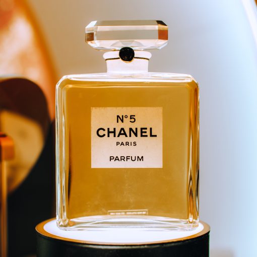 Close up golden glass bottle Chanel No. 5 perfume