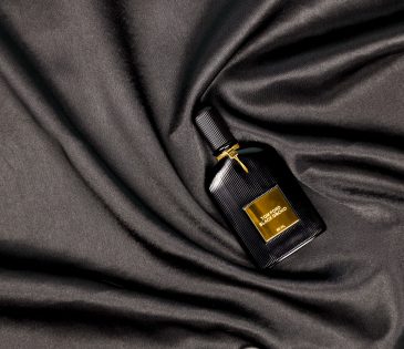 Tom Ford black orchid perfume on black satin background
