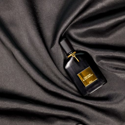 Tom Ford black orchid perfume on black satin background