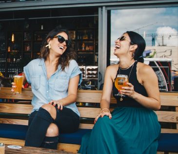Girls smiling at a bar