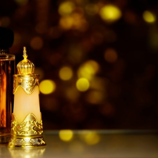 best arabian perfumes -glass perfume bottle dark background