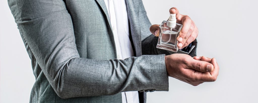 Man spraying cologne on his wrist