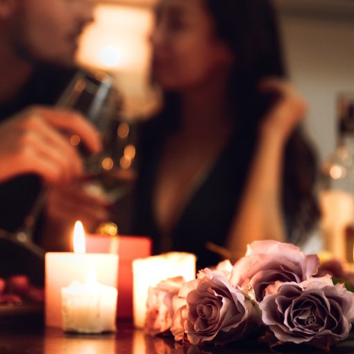 Beautiful passionate couple having a romantic candlelight date night