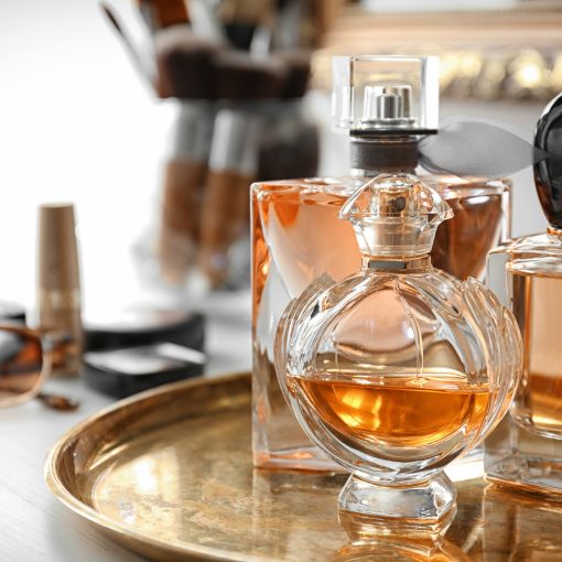 Metal tray with perfume bottles on table